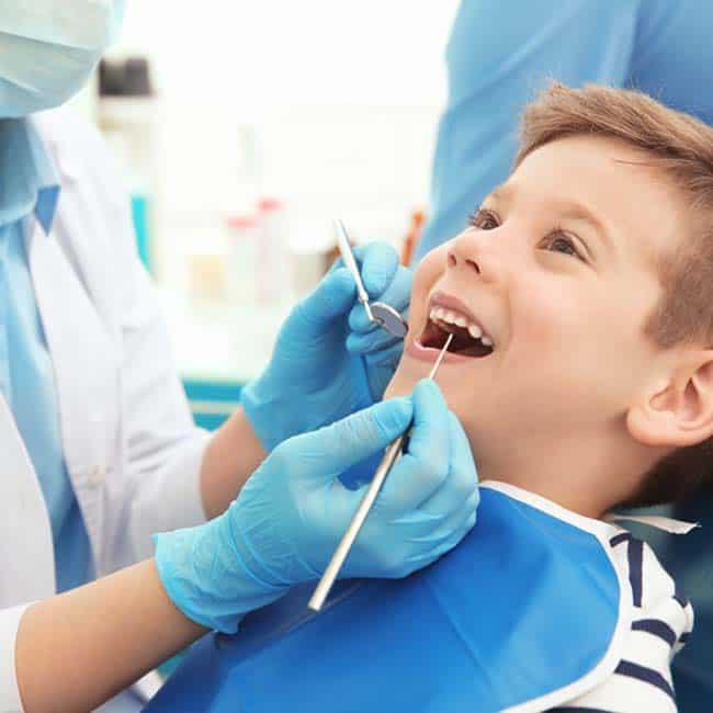 Child at the dentist getting a filling