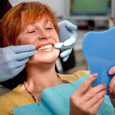 Woman being fitted with dentures